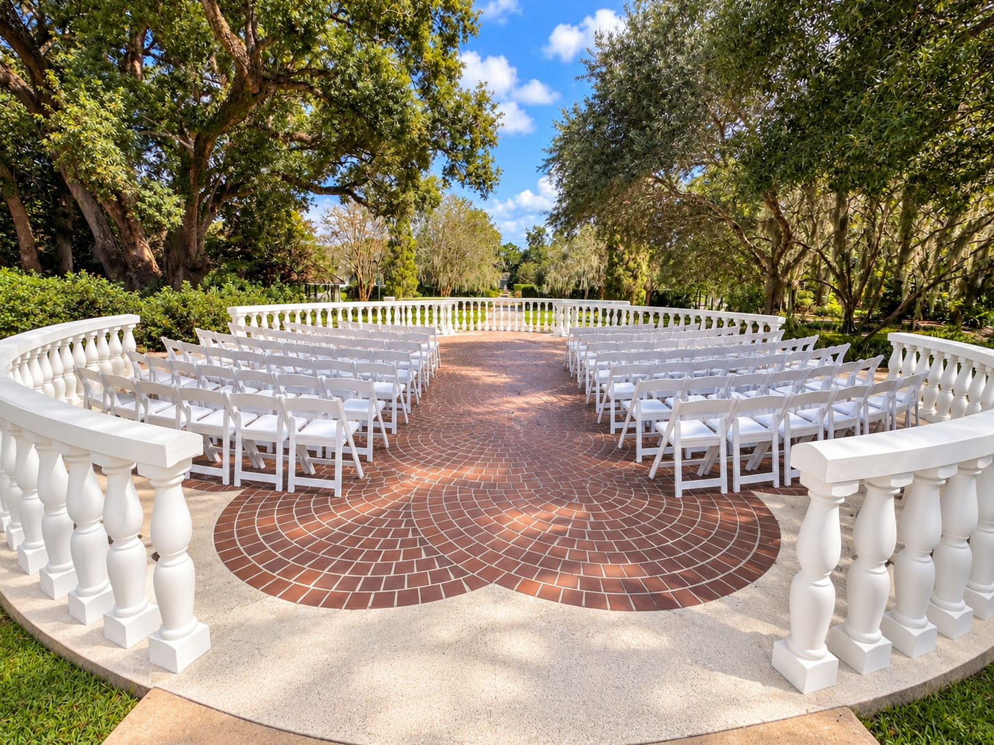 Photo of the Landing wedding site. It features white chairs, green trees, and beige and red bricks.