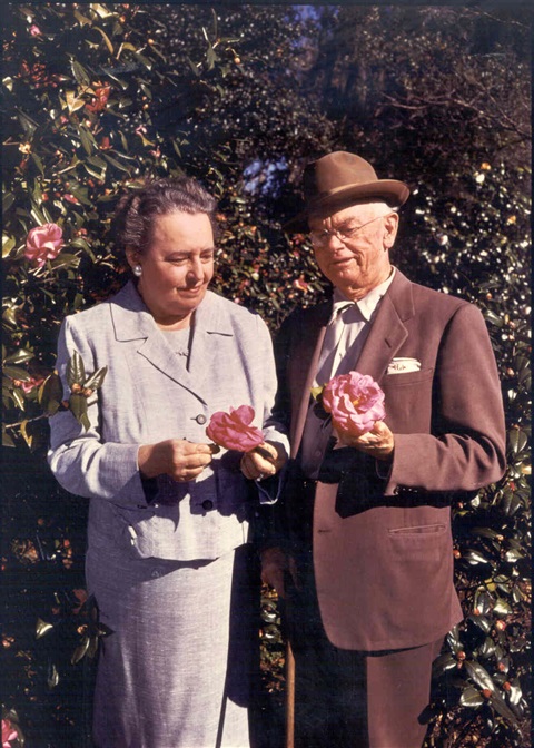 Harry P. and Mary Jane Leu holding pink camelia flowers