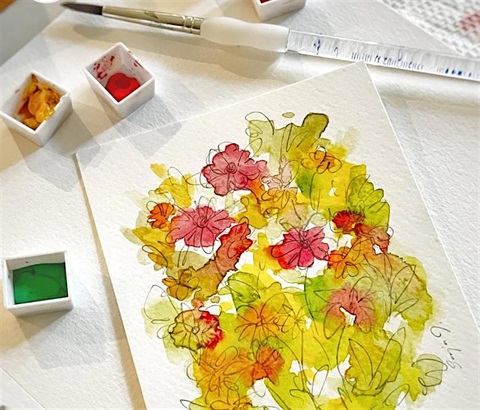 Watercolor painting of a floral design. It has yellow, red, orange, and green on it.