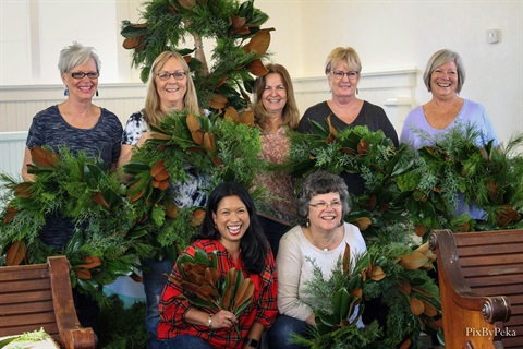 Workshop students holding their green wreaths.