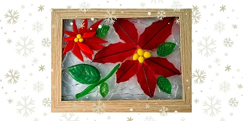 Glass mosaic of a red flower with green leaves and green stem.