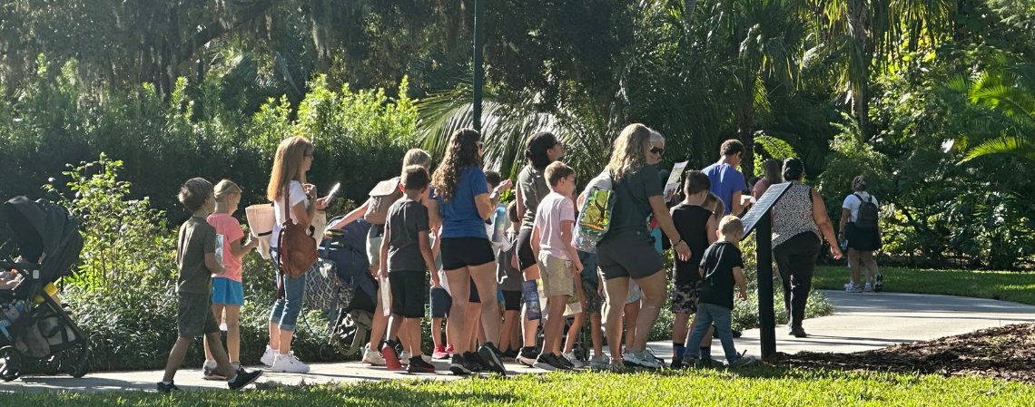 A group of kids walking on a path enjoying a tour of the gardens