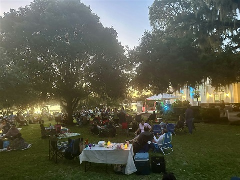 Guests sitting in chairs enjoying a Jazz concert in the garden