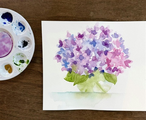 Watercolor painting of a bouquet of purple and blue flowers.