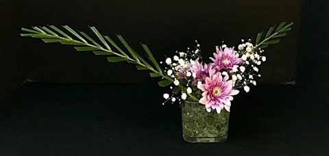 Ikebana flower display. The flowers are pink and white.