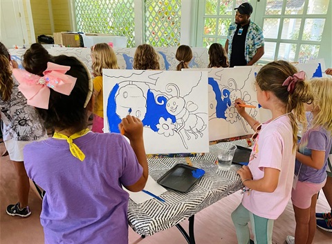 Children painting on canvas