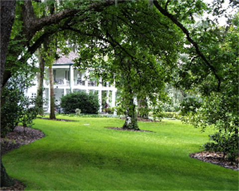A view of the Historic Leu House Museum from the Tropical Stream bridge.